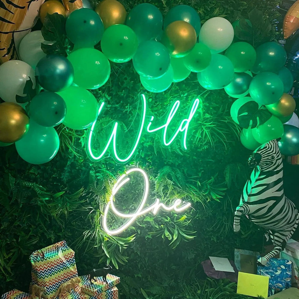 Custom neon sign lit as a photo backdrop at a party