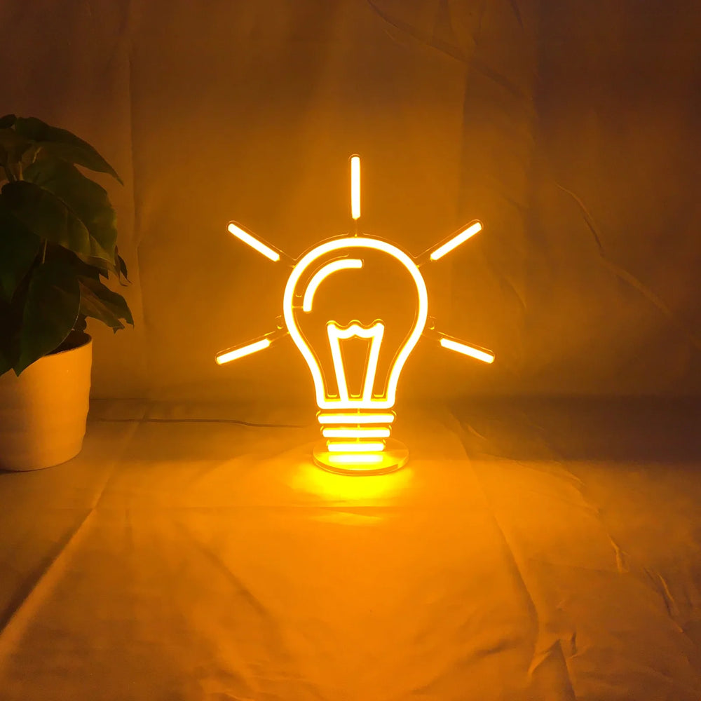 Small custom neon sign sitting on an office desk
