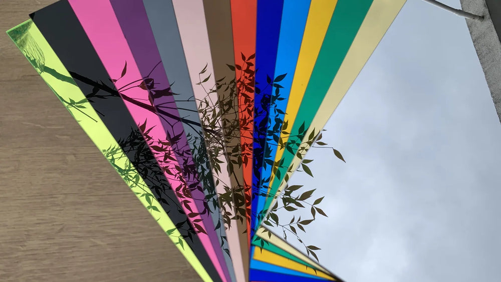 Mirror finish and coloured acrylic backboard samples fanned out side by side
