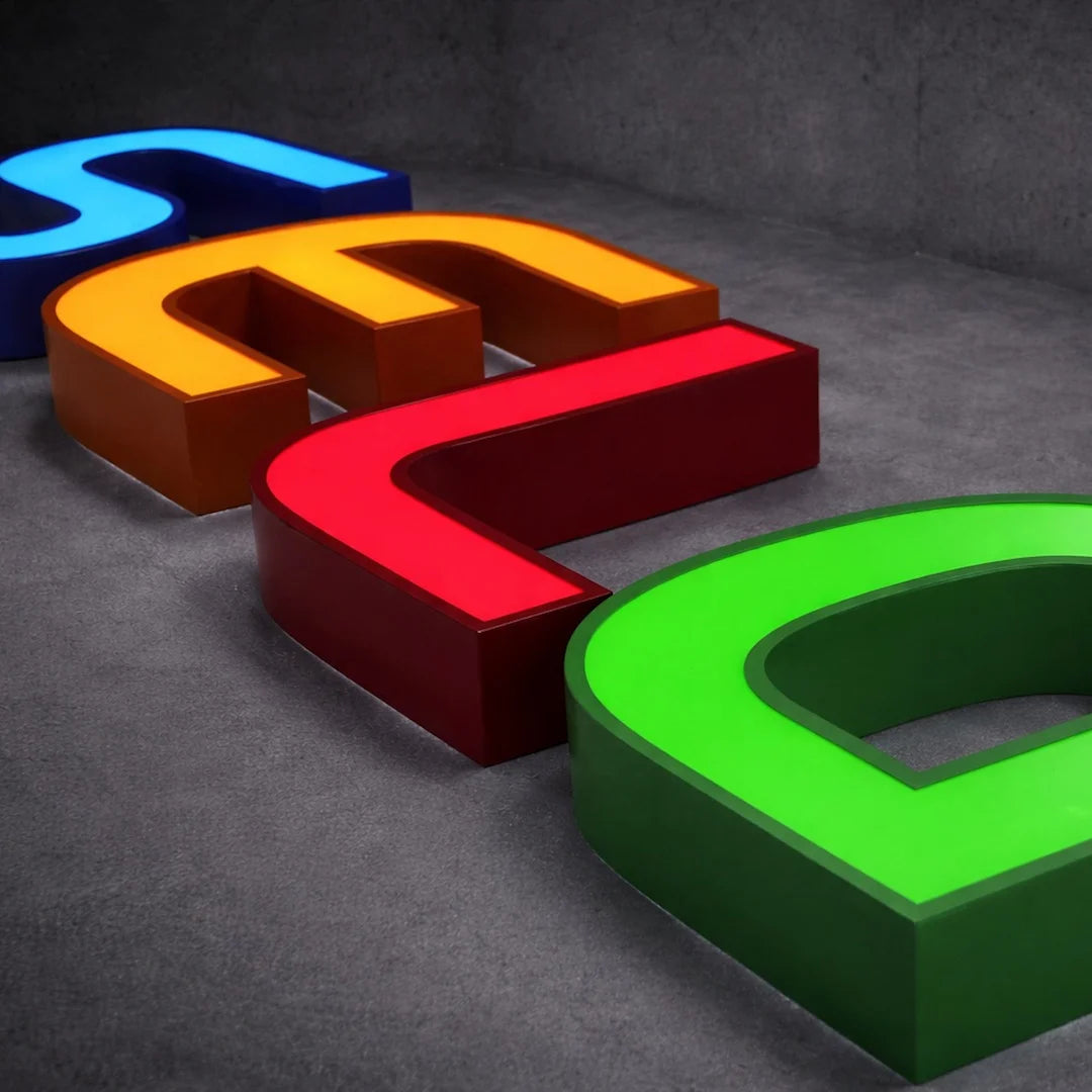 Custom front-lit channel letters with three dimensional individual letters made from metal returns and acrylic faces with internal LED illumination. The sign displays a business name, logo, or custom text in raised letter form mounted to a storefront facade, wall, or raceway. Each letter is fabricated as a separate illuminated unit with a bright face-lit front for clear visibility and structured commercial presentation. The installation is suitable for exterior storefront branding, retail facades, office en