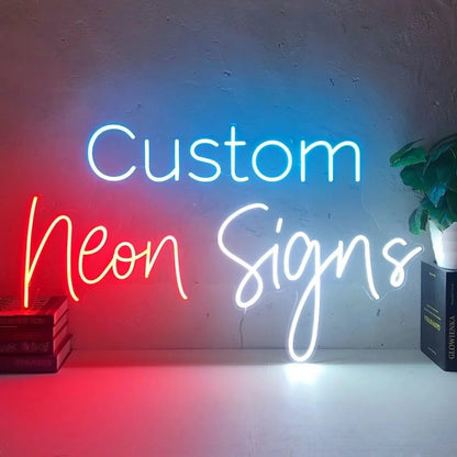 Custom LED neon sign with personalized text in blue, red, and white lettering mounted on a wall for business or studio display