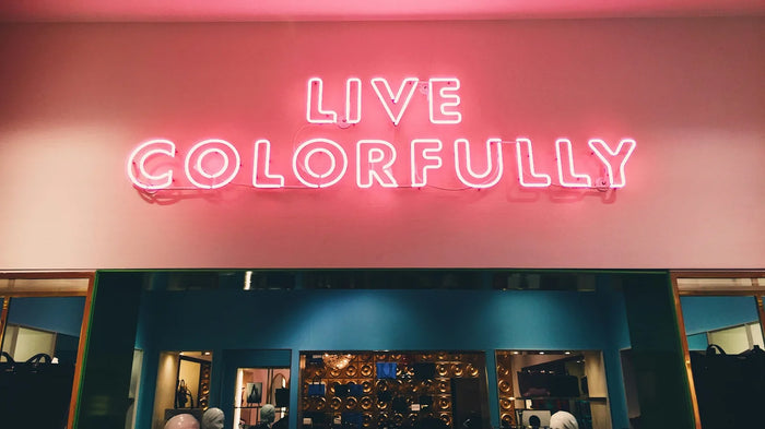 Hand-bent real glass neon lettering on a storefront at night